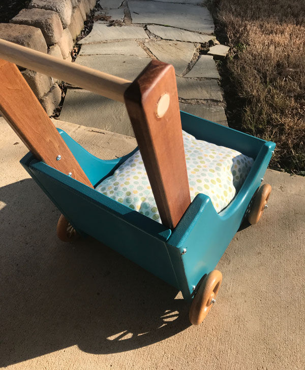 Finished stroller showing the round over edges and the beautiful contrast colors of the stained wood and blue paint. 