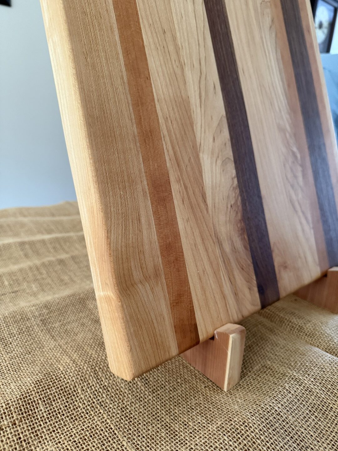 16” x 17” cutting board, made of black walnut, cherry, and maple, is ideal for smaller spaces.
